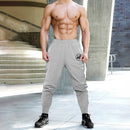 Pantalones deportivos para culturismo y gimnasio, pantalones de entrenamiento informales transpirables para hombre, pantalones de chándal finos sueltos de secado rápido con puños para correr