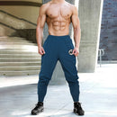 Pantalones deportivos para culturismo y gimnasio, pantalones de entrenamiento informales transpirables para hombre, pantalones de chándal finos sueltos de secado rápido con puños para correr