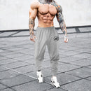 Pantalones deportivos para culturismo y gimnasio, pantalones de entrenamiento informales transpirables para hombre, pantalones de chándal finos sueltos de secado rápido con puños para correr